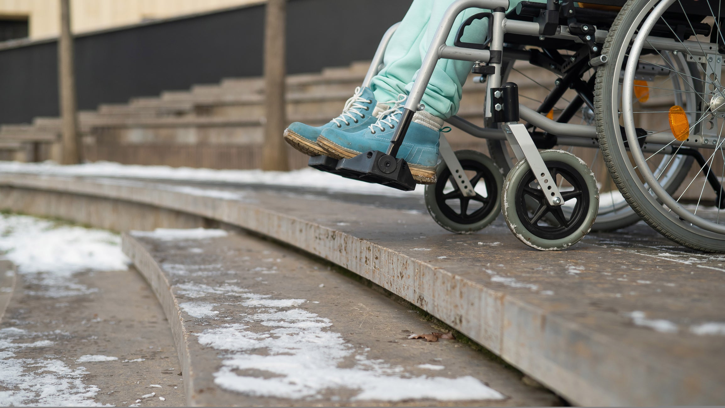 a person is in a wheelchair is at the edge of a stair step