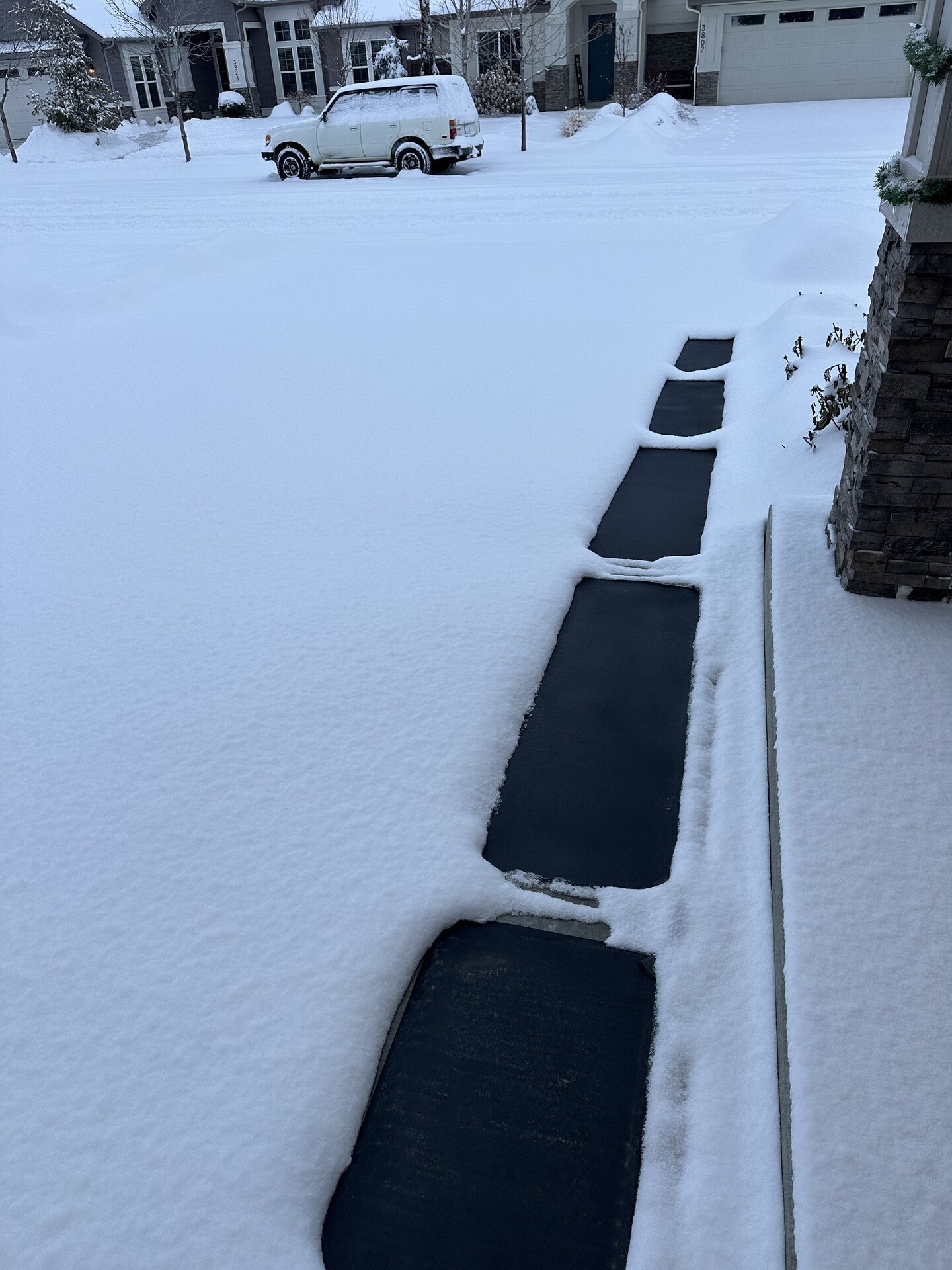 HeatTrak Snow melting walkway mats melting snow on path from house