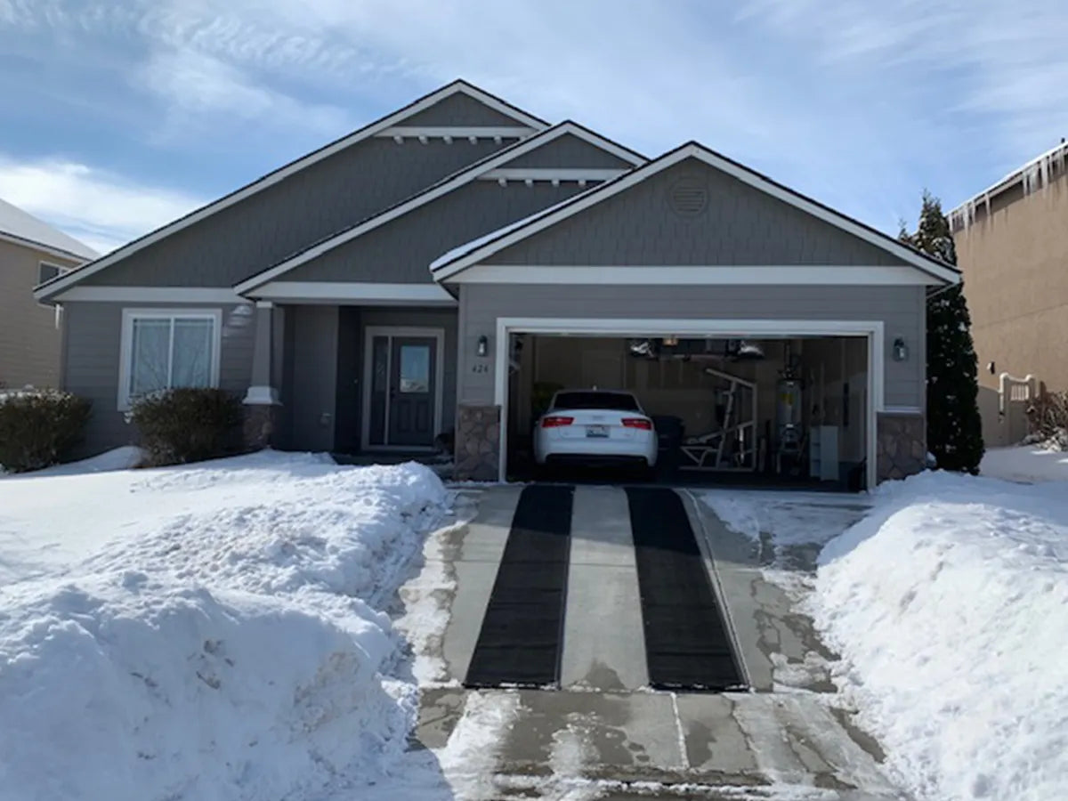 HeatTrak heated driveway mats melting snow and ice on a driveway.